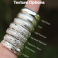 Stack of silver rings on a finger with text indicating different textures.